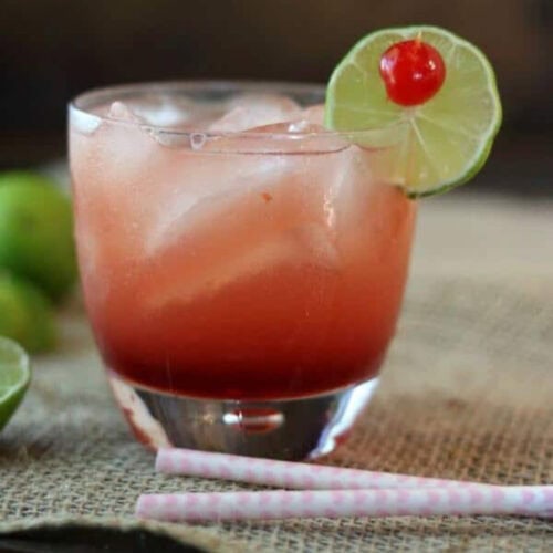 A cocktail on a dark background with title text overlay for Pinterest.