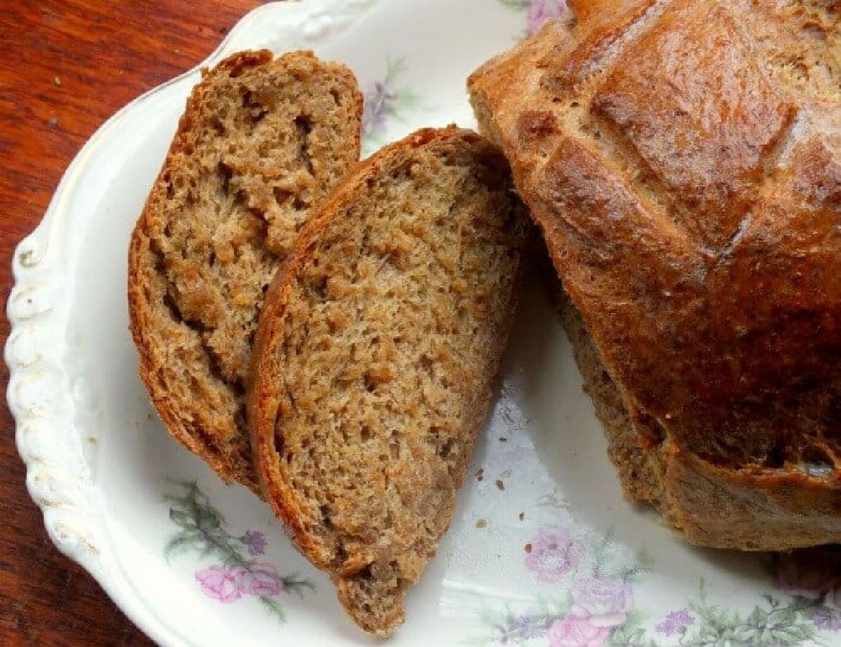 Overhead view of a loaf of Swedish rye bread that has been sliced.