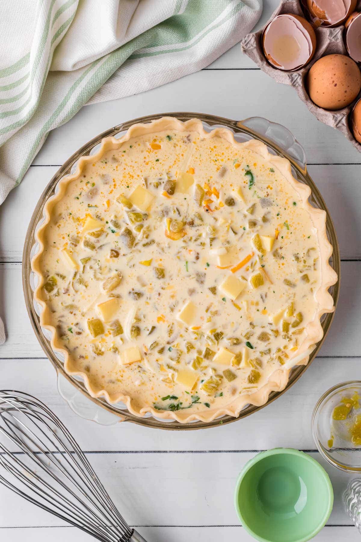 Step 4 of making the quiche - the filled pie shell is ready to be put in the oven.