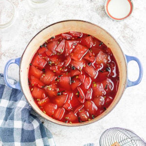 Overhead view of pickled watermelon rind in a pot.