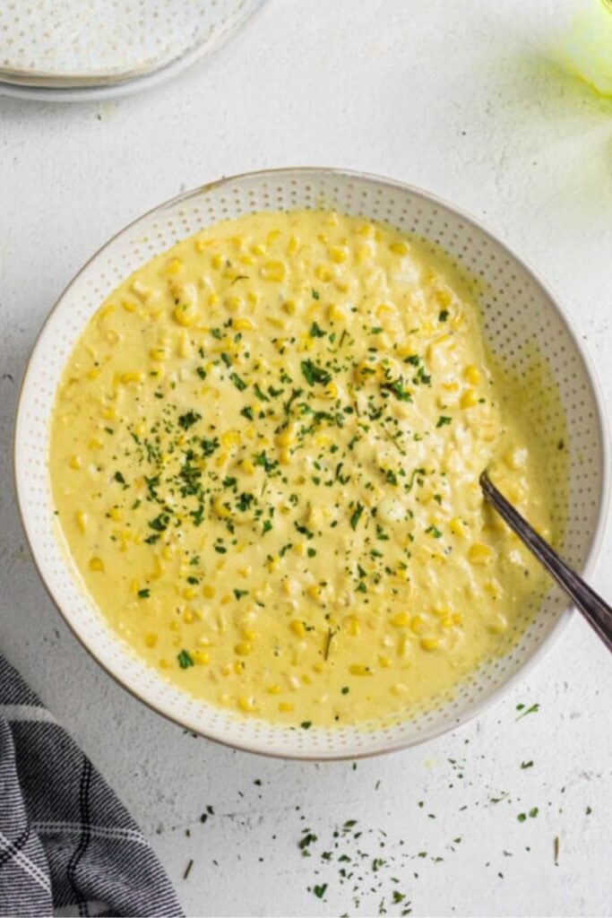 Overhhead view of creamed corn in a serving dish.