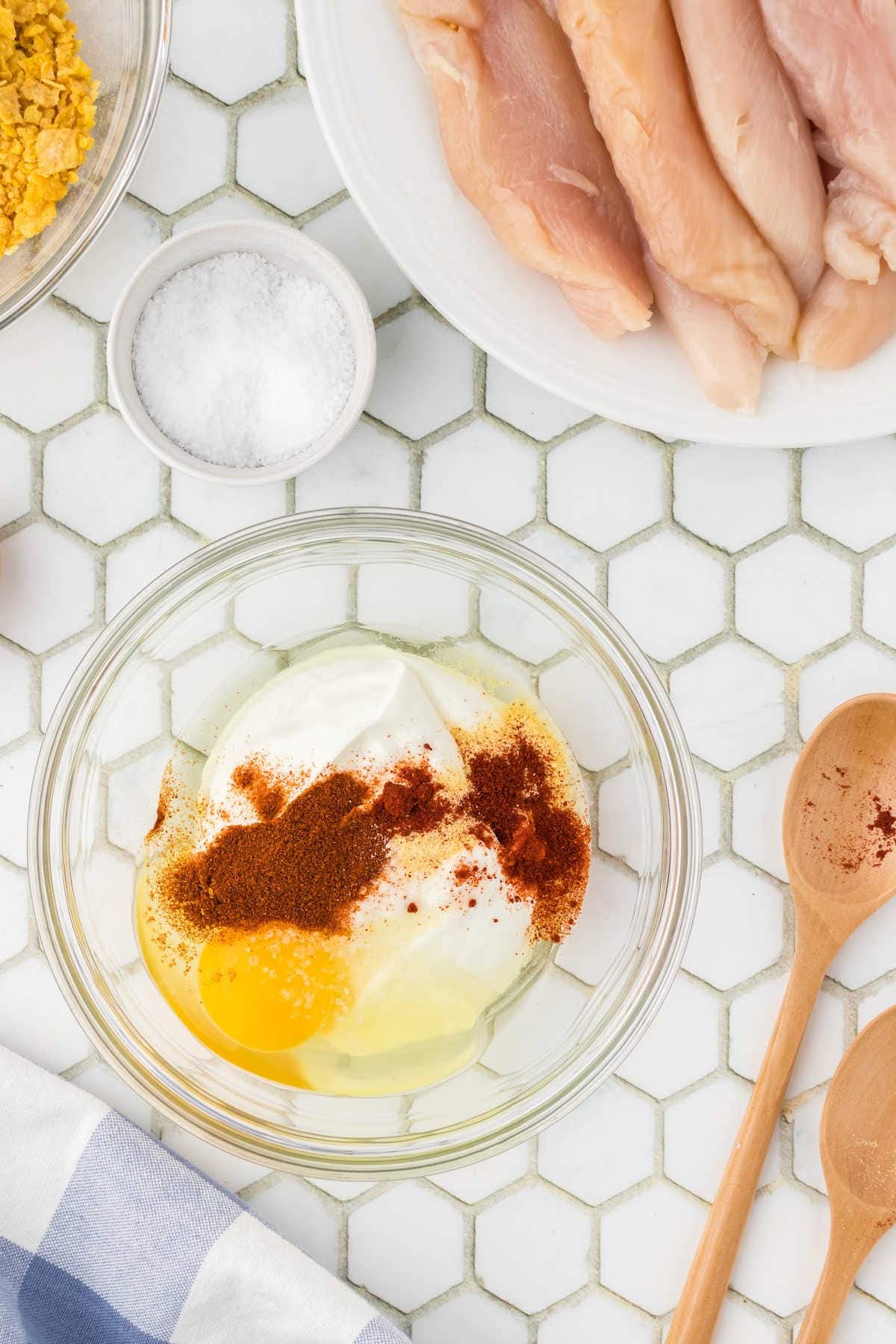 Herbs, eggs, and sour cream mixture to dip the chicken in.