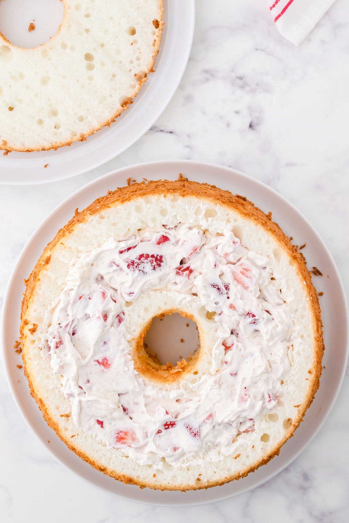 Fill the hollowed out cake with the strawberry and cream mixture.