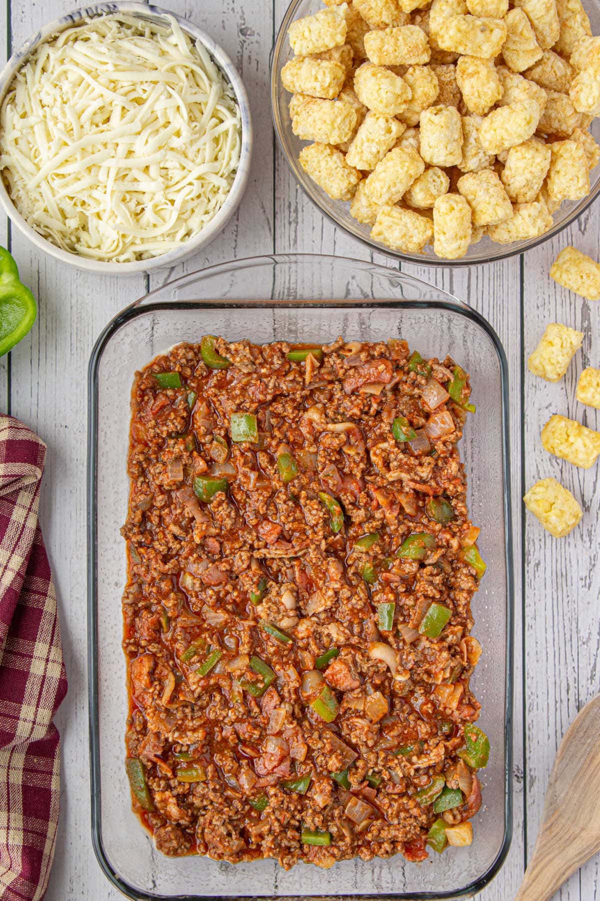 Cooked beef mixture in the bottom of the casserole dish.