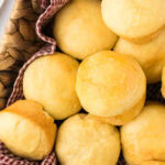 Overhead view of dinner rolls in a basket with a text overlay for Pinterest.