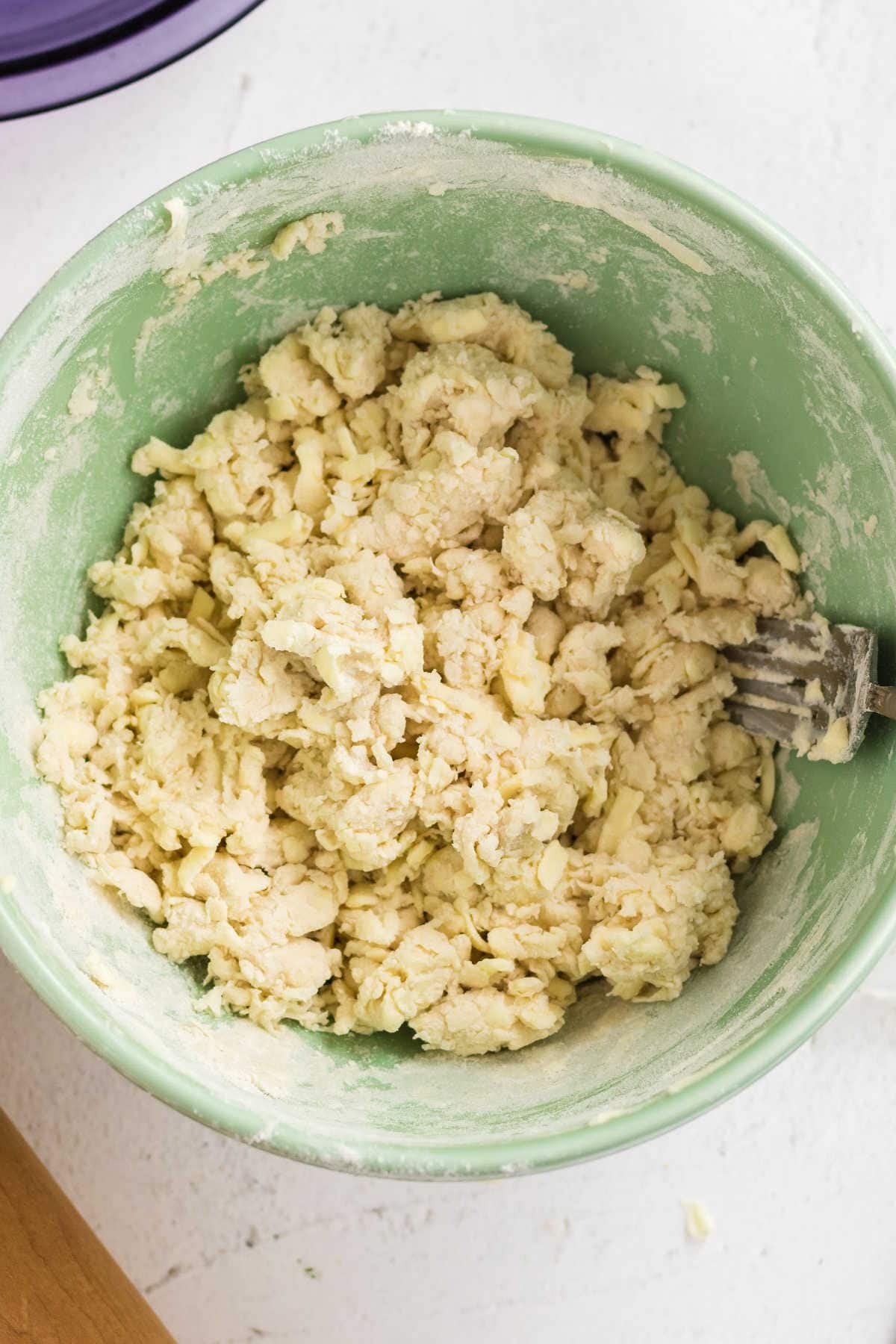Water added to flour mixture to form a dough.