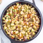 Cooked potatoes in a cast iron skillet.