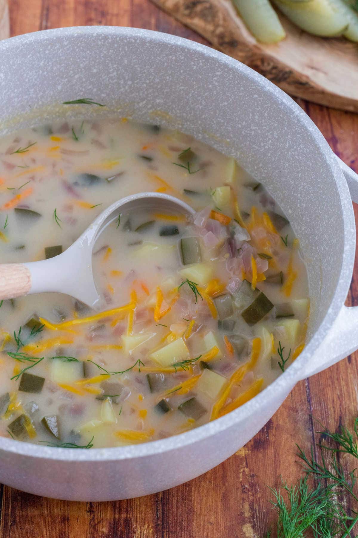 A ladle in a pot of soup.