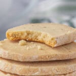 Buttery lavender shortbread cookies with a bit taken out.