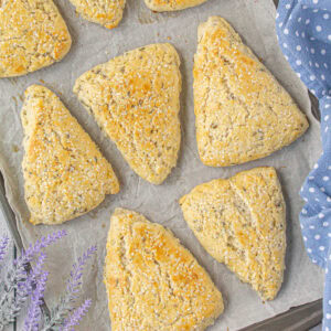 Overhead view of lavender scones on a baking sheet.