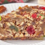 Closeup of a slice of fruitcake on a plate.