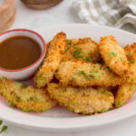 Finished chicken tenders on a plate.