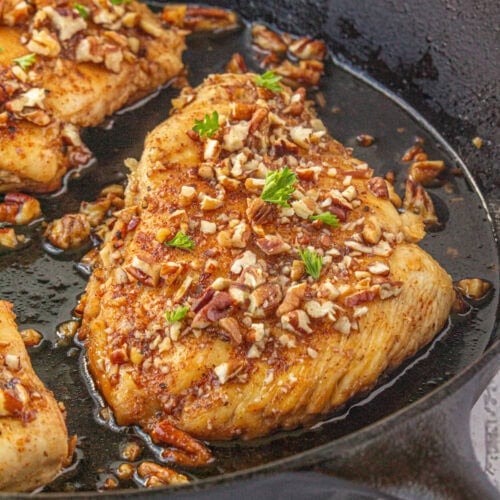 Honey pecan chicken in a cast iron skillet.