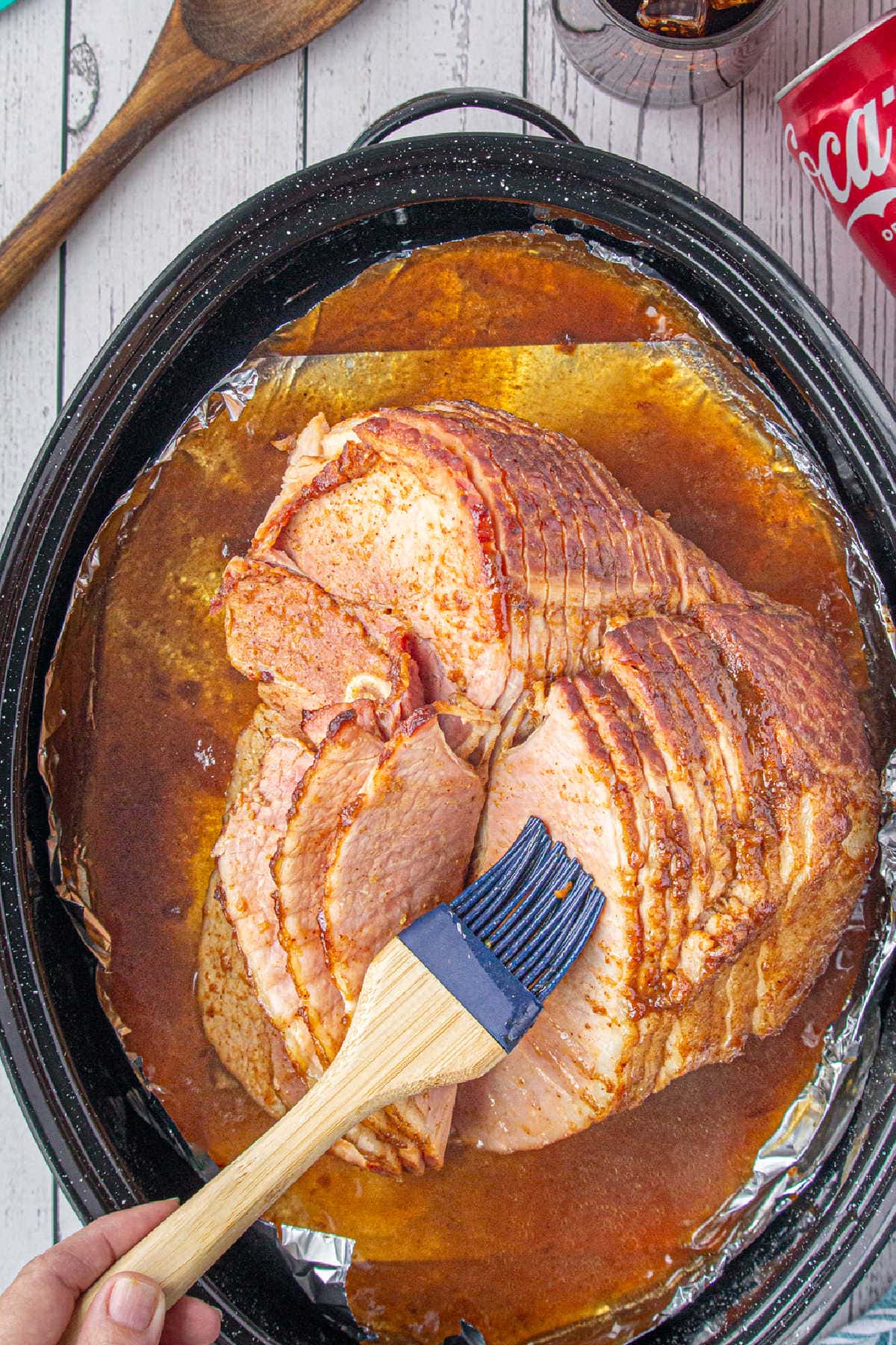 Ham being basted with a basting brush.