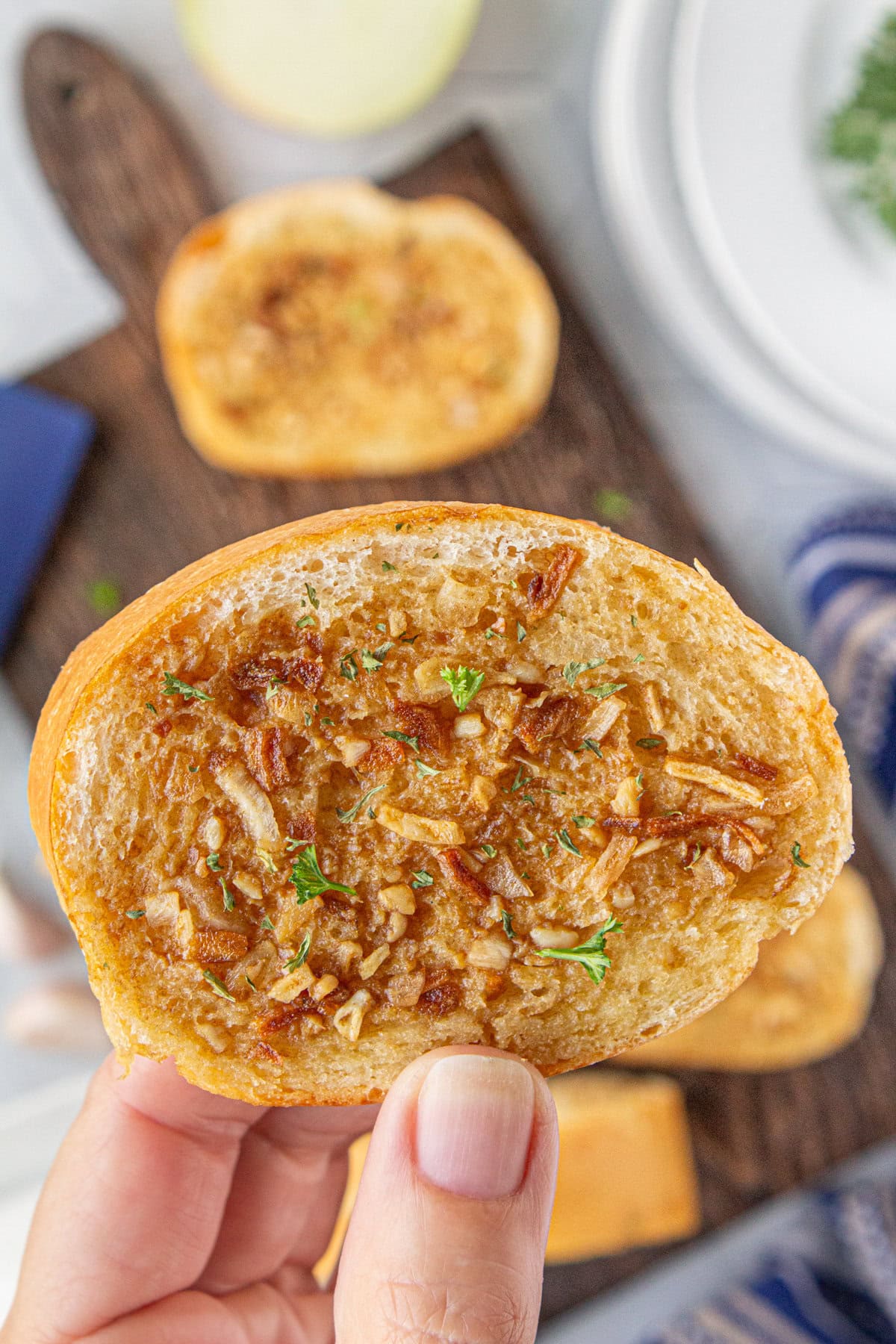 A close-up view of a slice of French onion garlic bread.