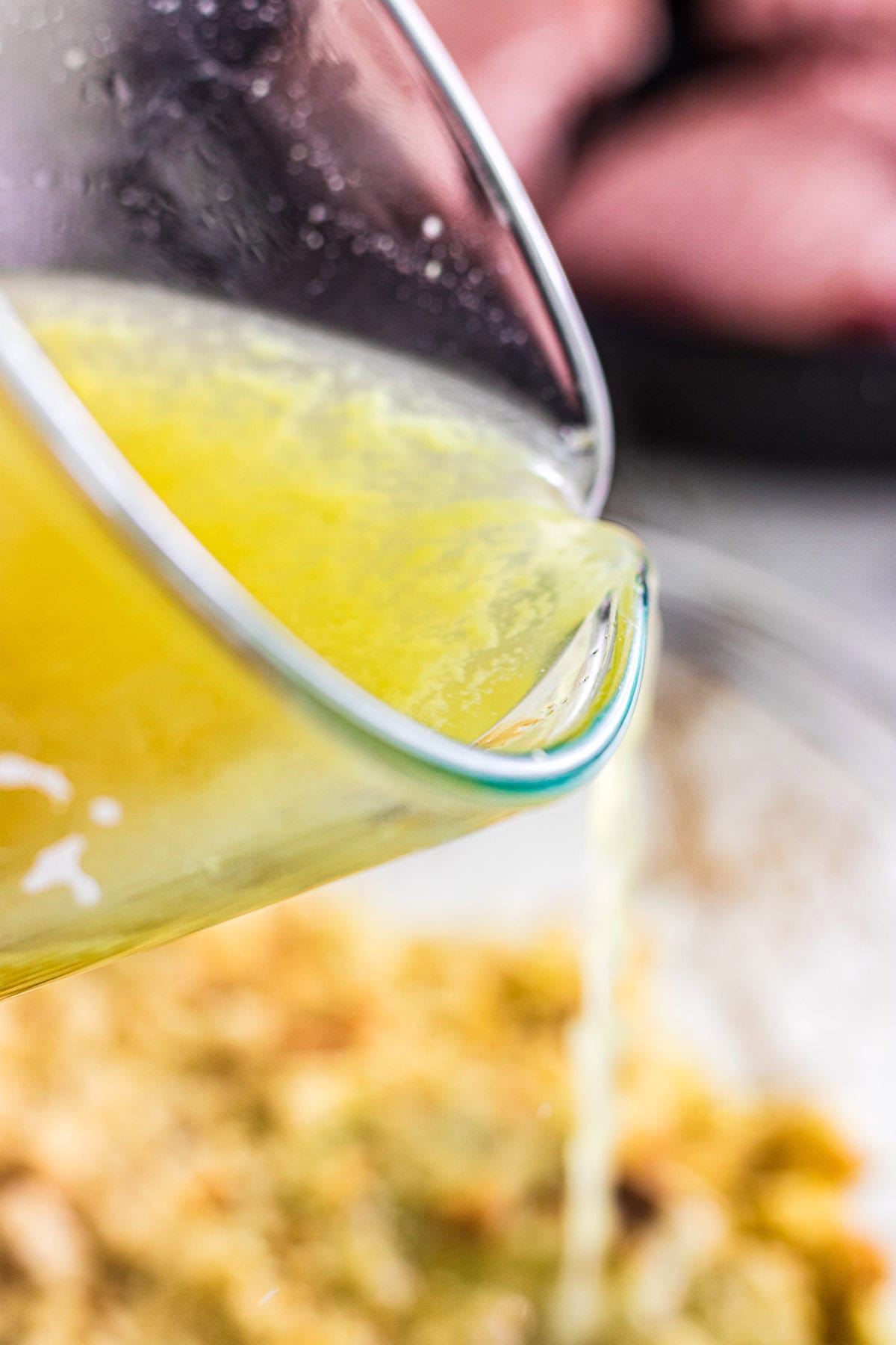 Pouring the chicken stock into the stuffing mix.
