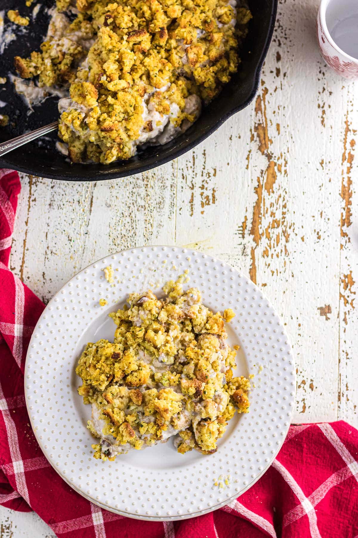 A plate of pork chops and stuffing casserole.