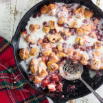 Overhead view of cherry bubble up in a skillet with a vanilla glaze.