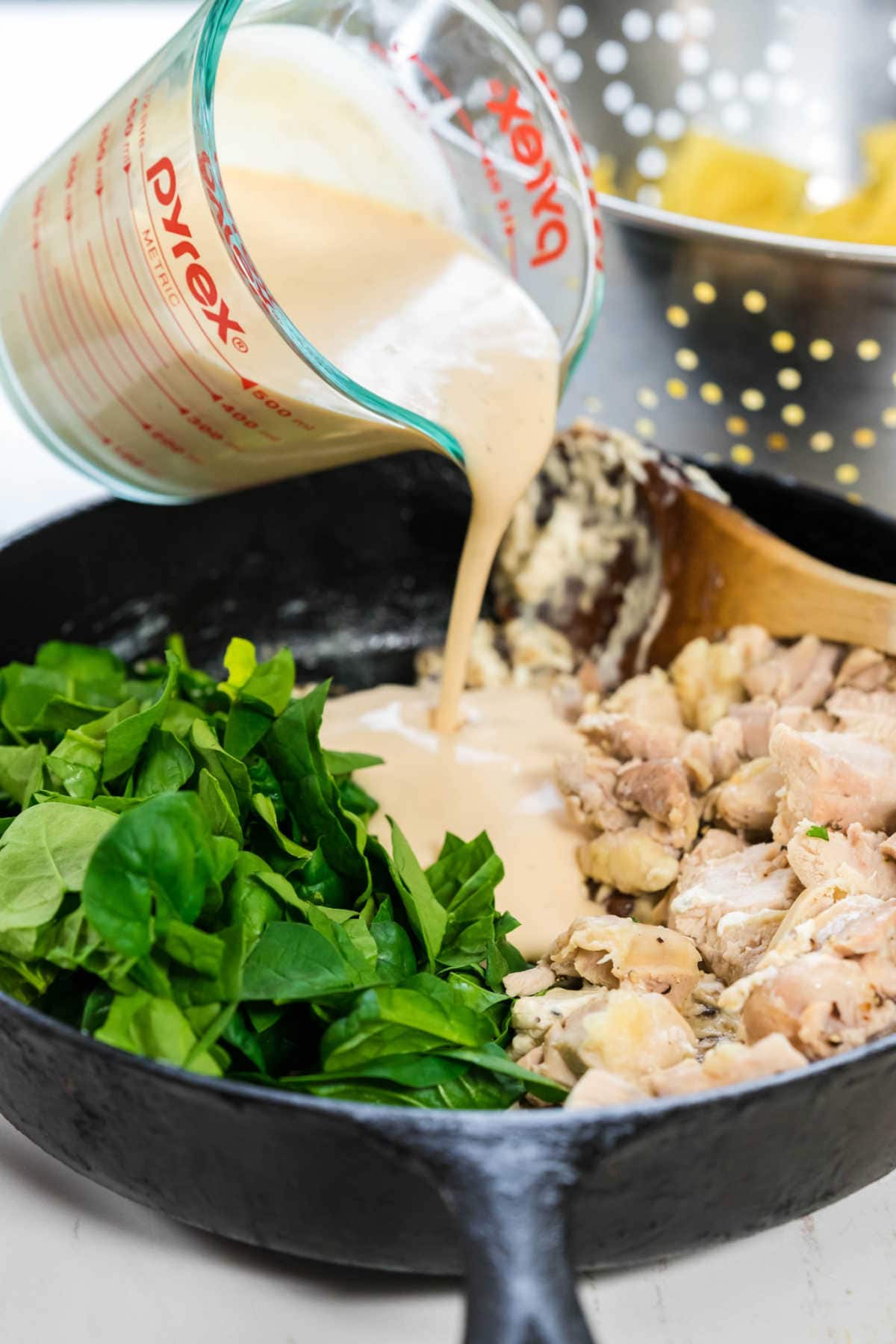 Sauce being poured on to the chicken mixture.