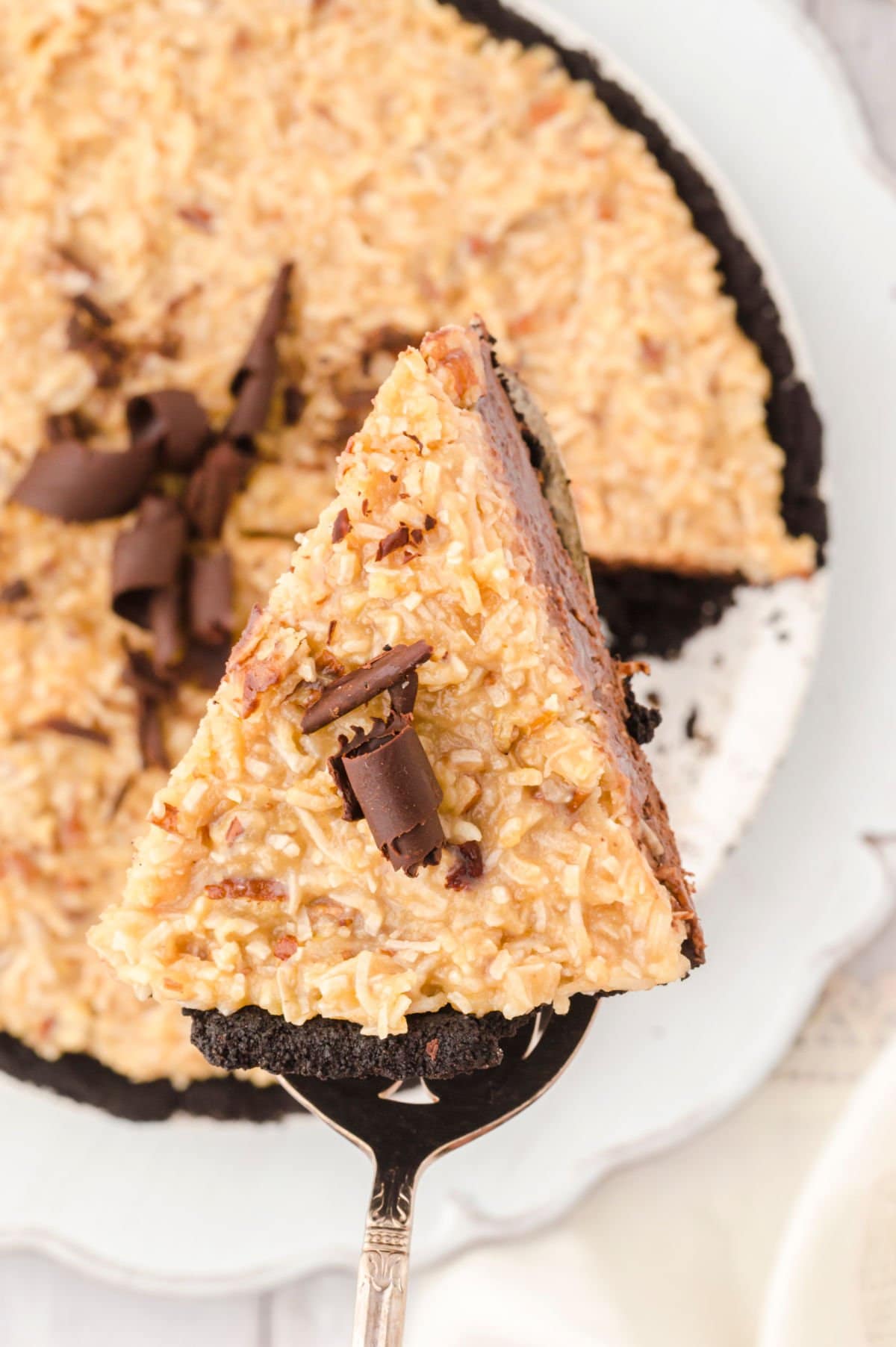 A slice of German chocolate pie being served.