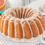 Finished Ruber Red grapefruit bundt cake on a white platter.