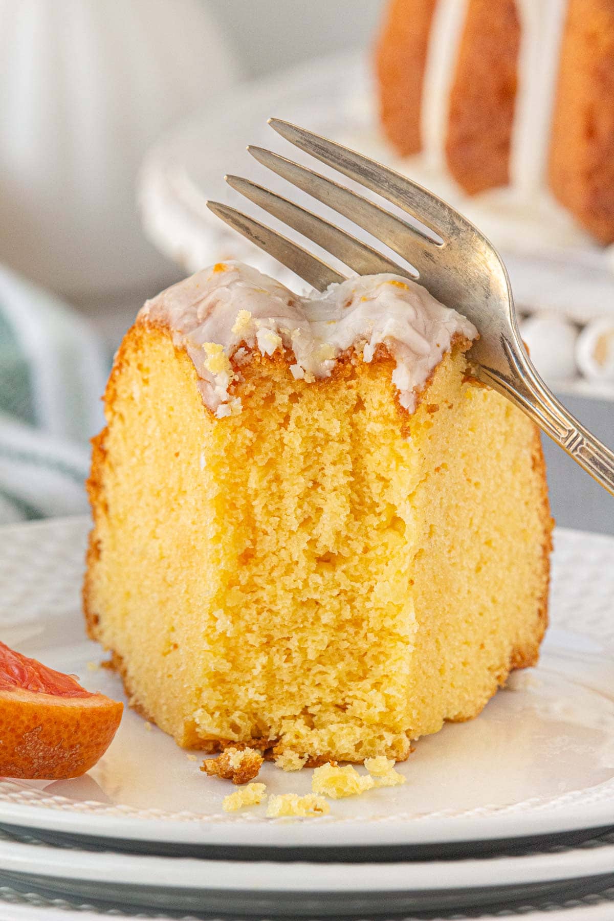A slice of Texas Ruby Red Grapefruit Cake on a plate.