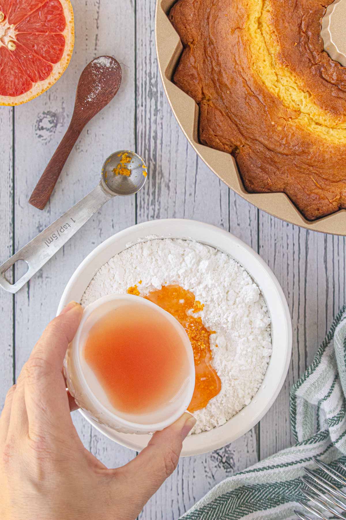 Grapefruit juice being added to powdered sugar for the glaze.