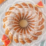 Overhead view of the finished grapefruit cake on a white cake plate.