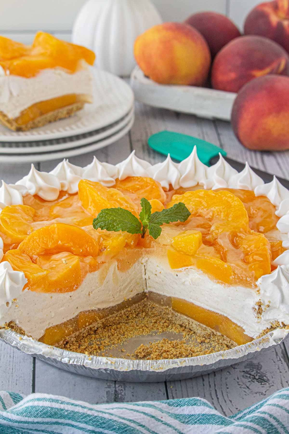 Peach icebox pie with a slice removed to show the layers of peaches and cream.