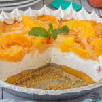 Peach icebox pie sliced to show the layers of peaches and cream.