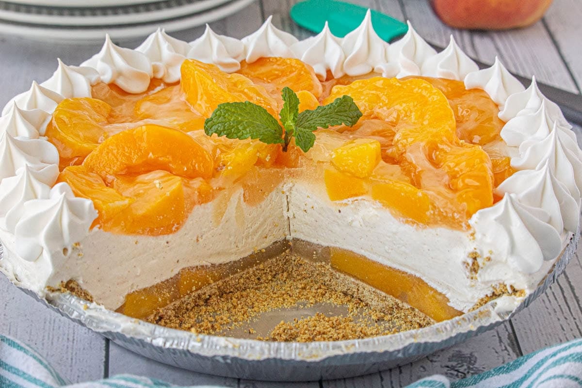 Peach icebox pie sliced to show the layers of peaches and cream.
