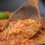 Closeup of tomato gravy in a skillet.