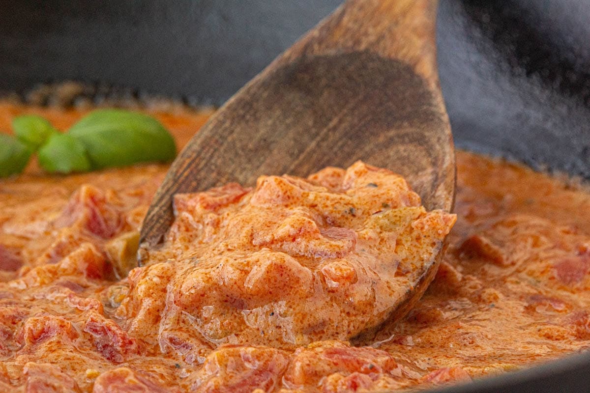 Closeup of tomato gravy in a skillet.