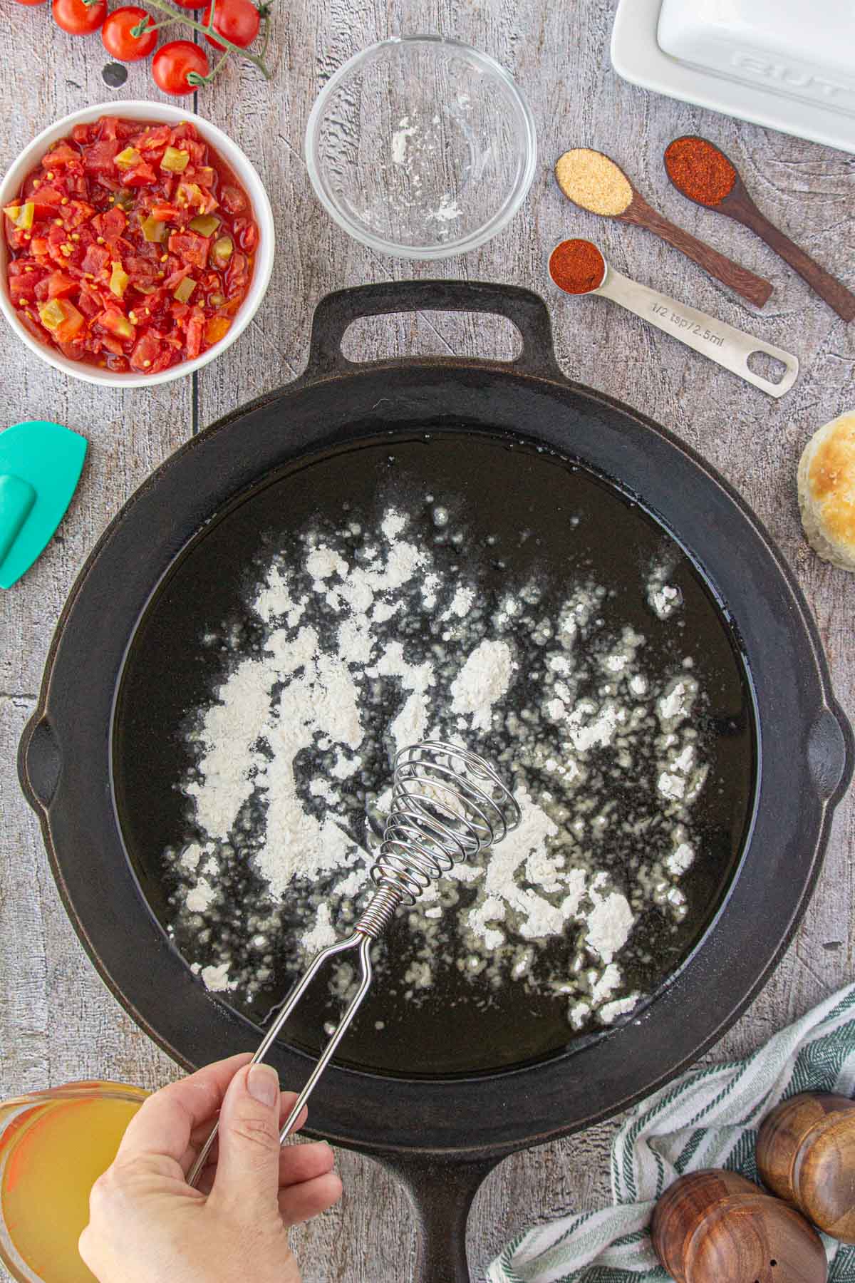 Flour added to skillet with bacon grease for the roux.