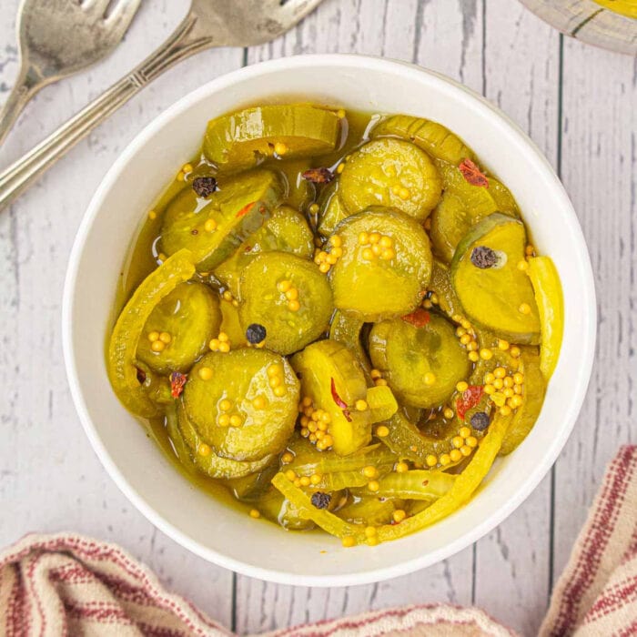 Overhead view of pickles in a white bowl