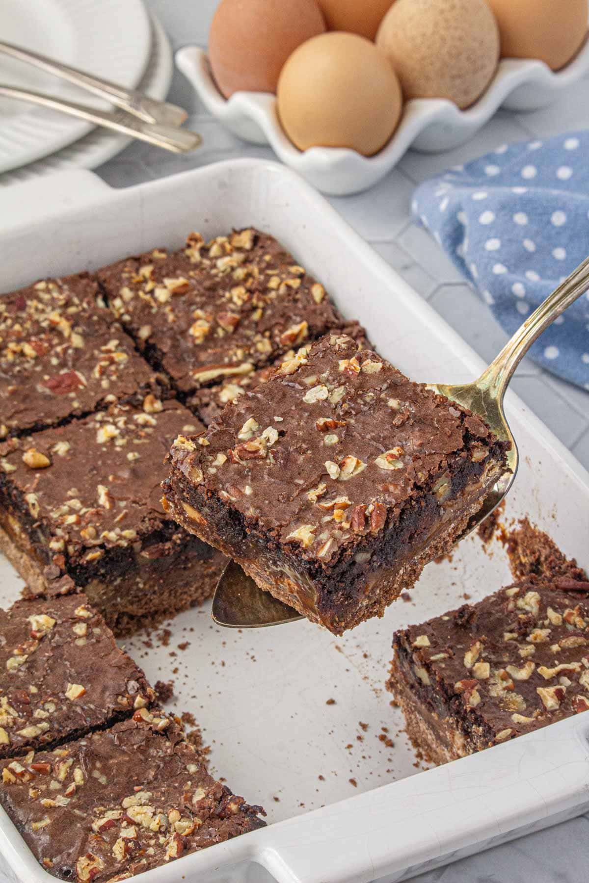 Semi-homemade caramel graham fudge brownies being served from the baking pan.