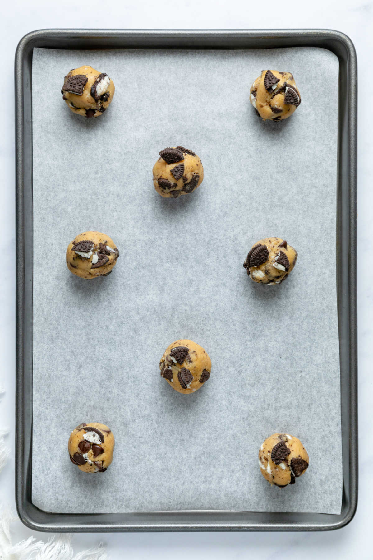 Balls of cookie dough on a cookie sheet.