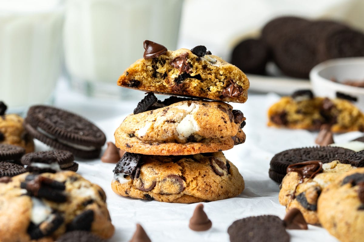 Finished homemade Oreo Chocolate Chip cookies cooling on parchment paper.