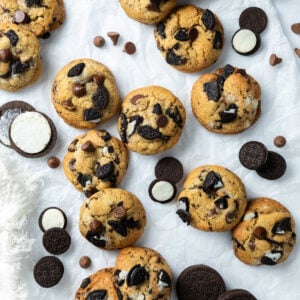 Oreo chocolate chip cookies on a piece of white parchment.
