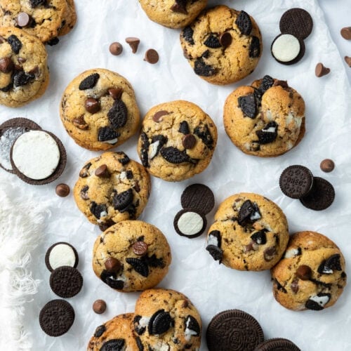 Oreo chocolate chip cookies on a piece of white parchment.