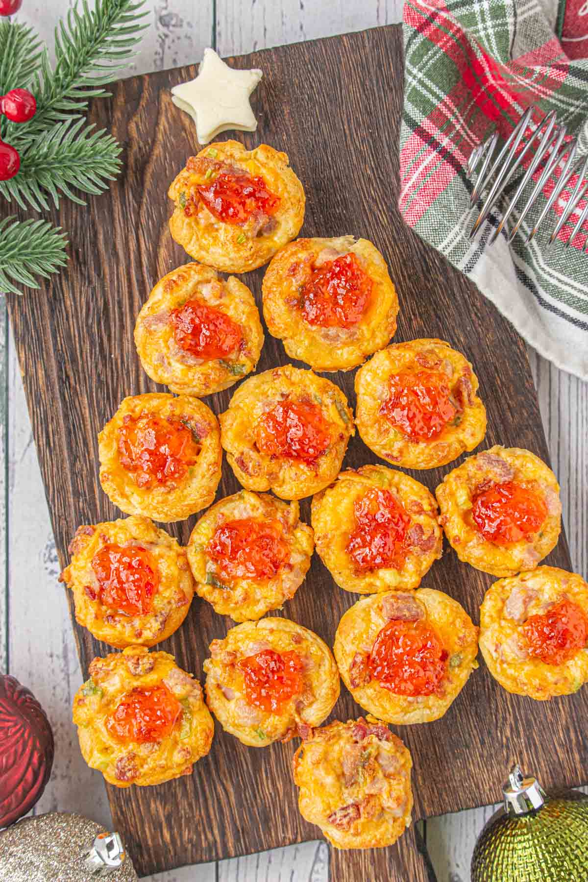 Cheddar ham cups appetizer set up on a charcuterie board to look like a Christmas tree.