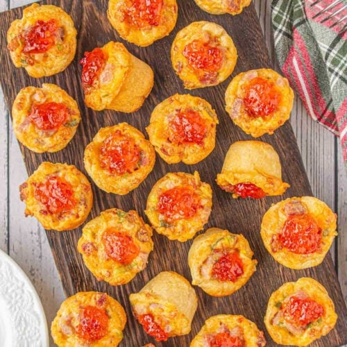 Overhead view of cheddar ham cups on a cutting board.