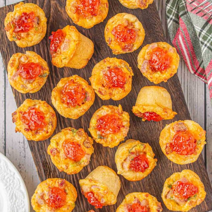 Overhead view of cheddar ham cups on a cutting board.