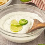 Closeup of jalapeno ranch dip in a glass bowl.