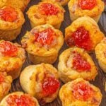 Cheddar ham cups on a wooden board with text overlay for pinterest.