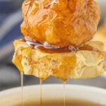 Maple syrup dripping off a chicken and waffle skewer with text overlay for pinterest.