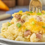 Cheesy ham and grits casserole on a plate.