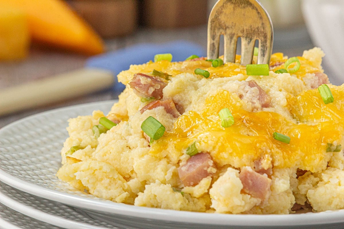 Cheesy ham and grits casserole on a plate.