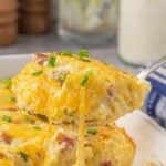 Cheesy grits and ham breakfast bake being served. Title text overlay for Pinterest.