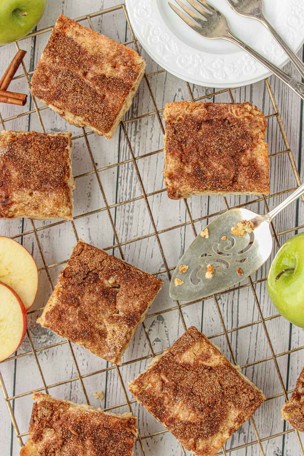 Apple snickerdoodle bars with cinnamon topping on a cooling rack.